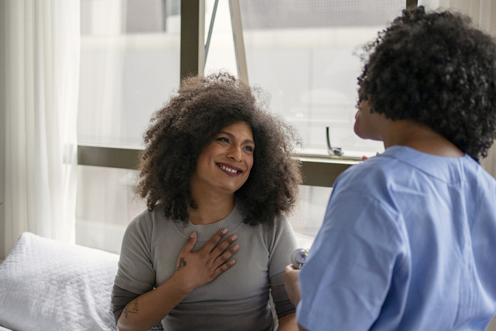 A patient looks at their primary care provider with a grateful smile