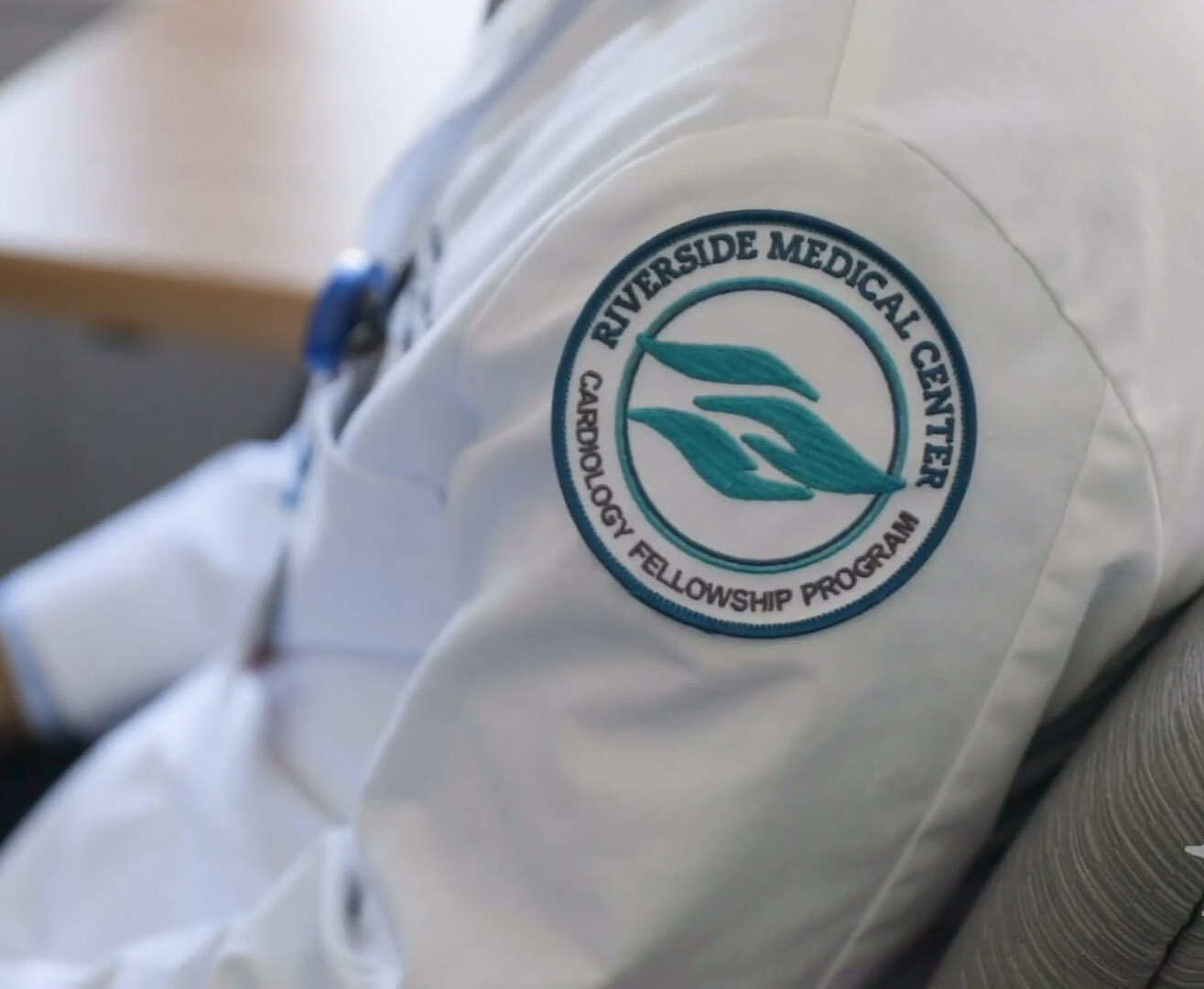 white lab coat with Riverside GME Program patch stitched on the shoulder
