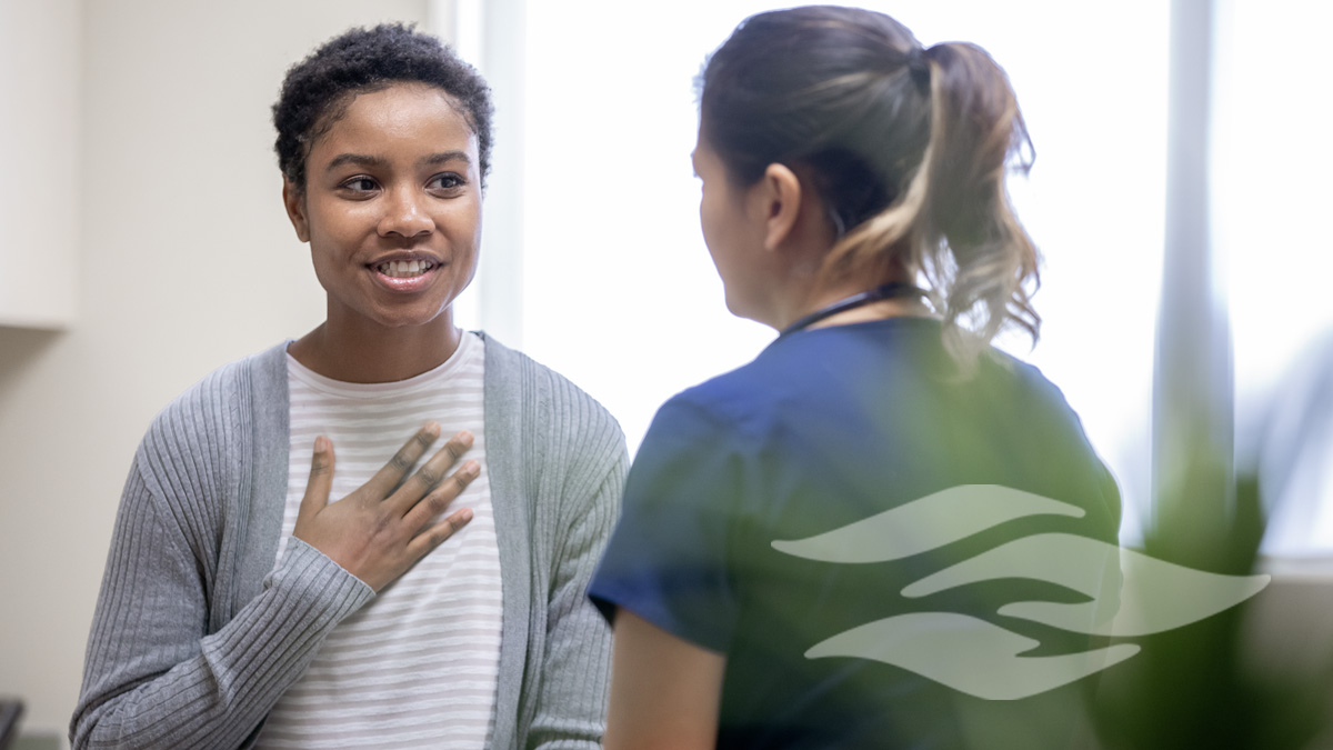Nurse explaining good news to female patient