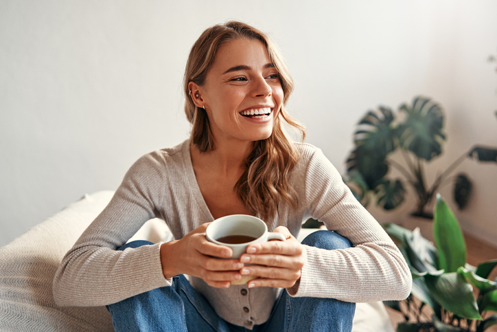 Smiling Woman Drinking Coffee