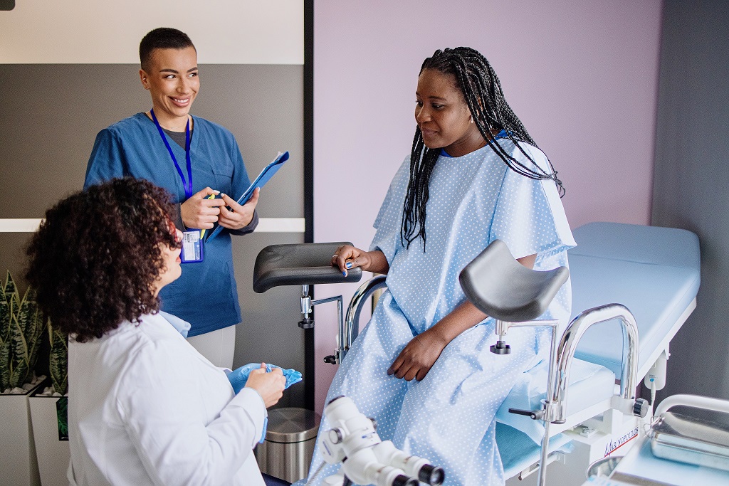 Doctor and nurse speak to patient during Well Woman visit