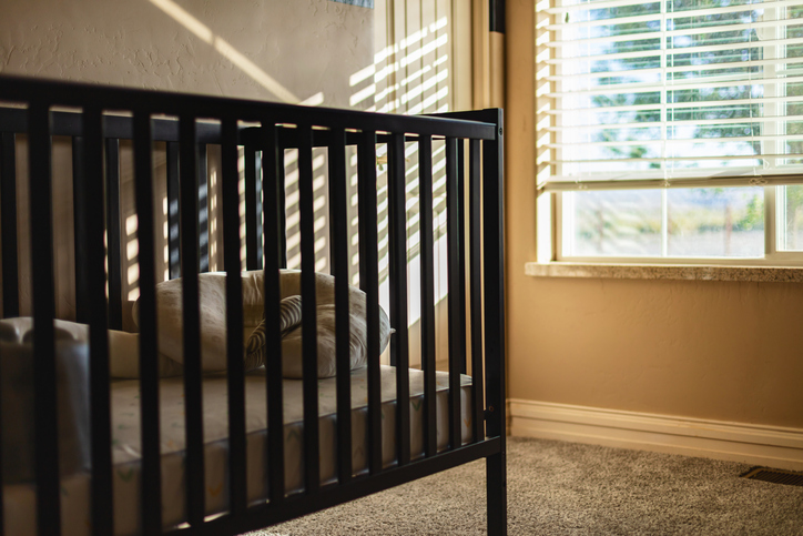 A crib sits in a bedroom