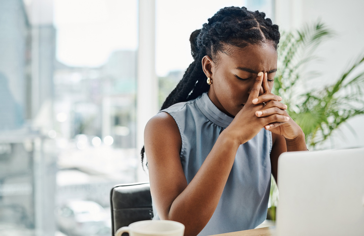 Stressed Woman with Head in Hands