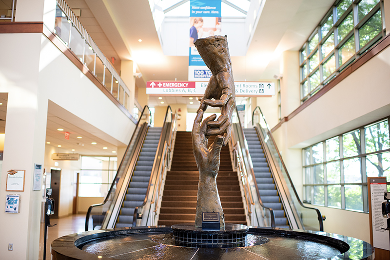 Image of a statue of two hands located in the main lobby of Riverside Outpatient Center