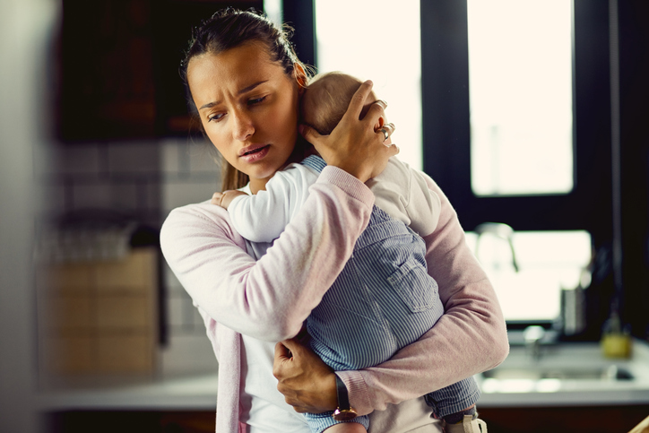 Sad woman with baby