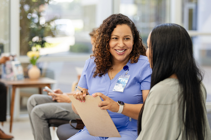 Female nurse and woman talking together