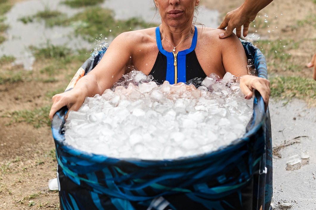 Athlete woman taking ice bath after running workout