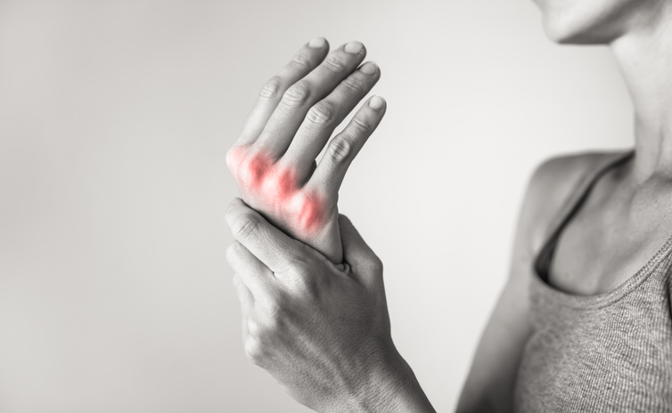 Woman suffering from pain in hands and fingers