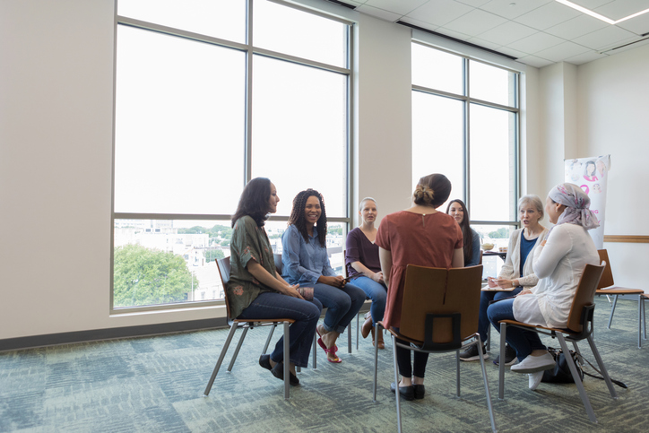 women meet in circle for a support group
