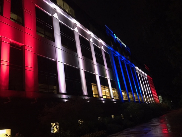 Riverside Medical Center lit up with red, white, and blue lights