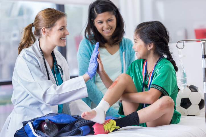 Emergency room doctor gives young patient a high five