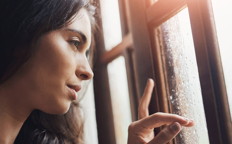 Woman Looking Out Window