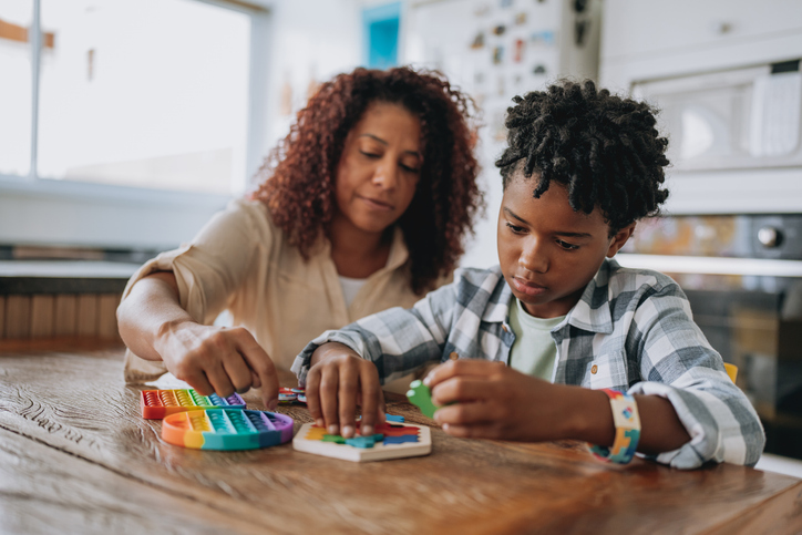 Mother playing with autistic son