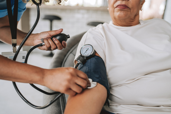 Doctor checking a woman's blood pressure