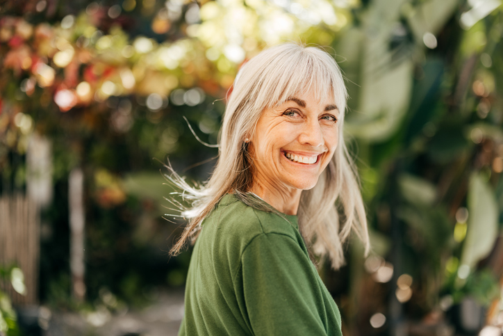 Woman smiling while wearing green