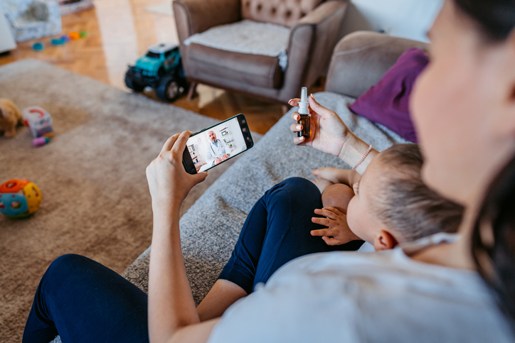 Mother and child connecting with a Riverside provider through a telehealth video visit