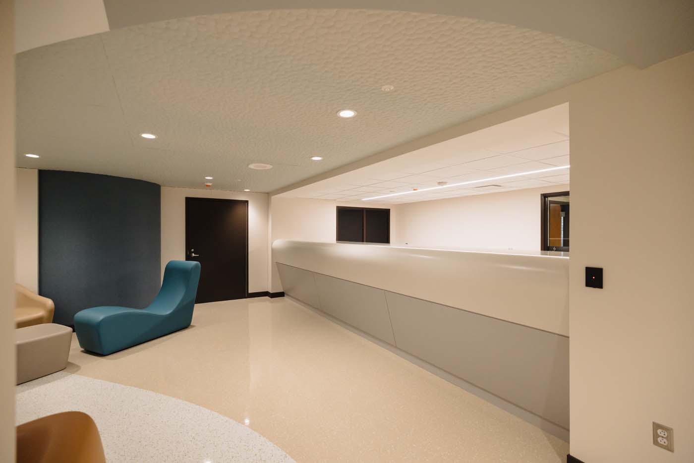 Open care team station with clear sight lines down the patient hallway.