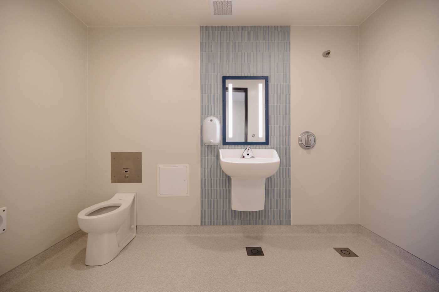 Patient bathroom with safety-designed fixtures and slip-resistant flooring.