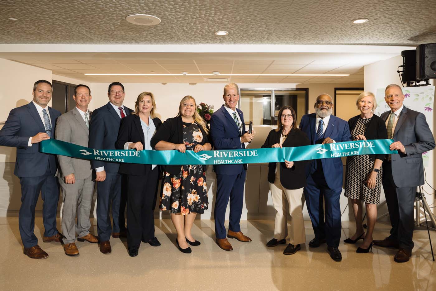 Riverside Healthcare leadership team stands behind the ribbon at the opening of the new adult inpatient behavioral health unit.